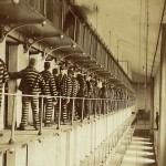 Prisoners standing in front of their cells. Joliet Prison.